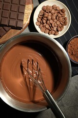 Chocolate dough in bowl and ingredients on grey table, flat lay