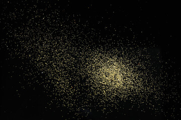 Beautiful shiny golden glitter on black background, top view