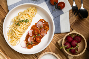 Delicious food's special menu homemade preparing station spaghetti with minced meat top tomato sauce and basil shooting placing elements serving with chef table surround decorative spices. Postulate.