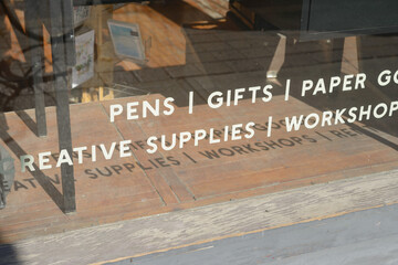 Naklejka premium display window with new and vintage objects vinyl lettering signage at Paper Plus Cloth - Japanese Stationery, Paper and Pen Store, located at 1340 Queen Street West in Toronto, Canada