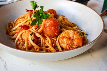 Seafood Linguine Pasta with Tomato and Herbs. A delectable bowl of seafood linguine pasta garnished with fresh parsley.