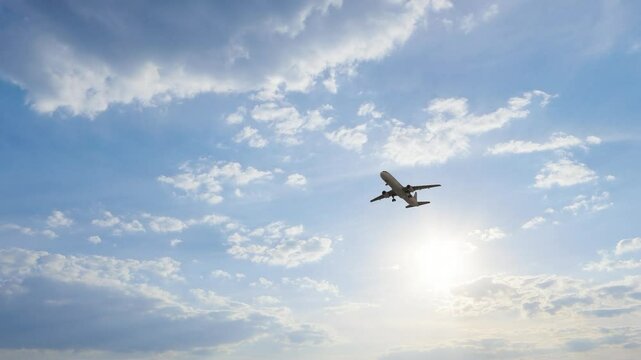  ULTRA HD. 4K. Airplane flies in blue sky. Travel, tourism. Airplane takes off against the background of blue sky. 