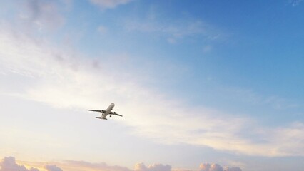ULTRA HD. Airplane flies in sunset sky. Travel. Airplane takes off against the background of sunset...