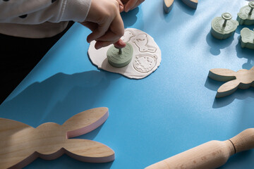 Workshop cutting figures Unrecognizable artist do it yourself air dry clay crafts for Easter...