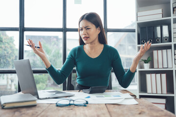 Frustration at the Desk: A businesswoman experiences a moment of exasperation as she faces a challenging situation at her desk.