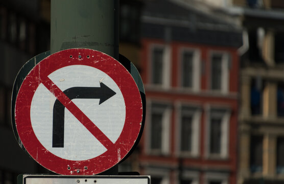 No right turn sign with colorful buildings in background