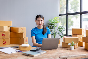 Startup small business entrepreneur SME, asian woman receive order on laptop. Success young Asian small business owner at home, online sell marketing delivery, SME e-commerce telemarketing concept
