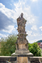 Fototapeta premium Sculpture of St Wojciech Adalbert of Prague by father and son Brokoff on the Charles Bridge in Prague in Czech Republic