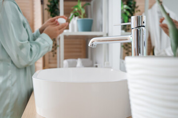 Modern sink in light bathroom