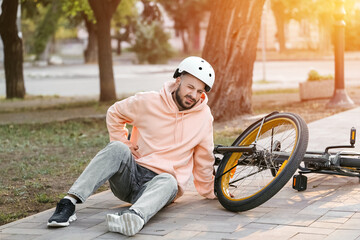 Young man injured after falling off his bike in park