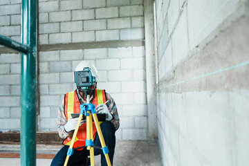 Surveyor Working on Construction Site with Equipment