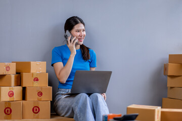 Startup SME small business entrepreneur SME or freelance Asian woman calling phone, online marketing packaging box and delivery, SME concept
