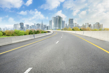 Fototapeta premium Smart city with empty road leading to cityscape