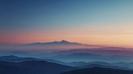 A breathtaking view of mountain ranges at sunset, with layers of blue hues and a warm orange sky. Silhouettes of mountains against a vibrant sunset sky