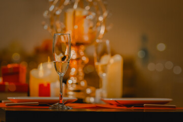 Crystal glasses filled with Champagne for New year's eve. cheering with champagne. Couple at home celebrating.