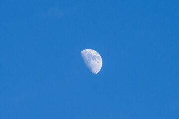 A bright moon in a blue sky