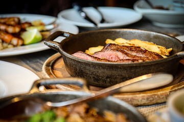 Grilled steak and fries served in a cast iron skillet