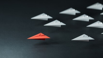 Different business concept.new ideas. paper art style. creative idea.Leaderplane concept with red paper plane leading among white.3D rendering on black background.
