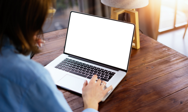 Mockup image of a woman using laptop with blank screen. Transparent. Cut out. PNG - Powered by Adobe