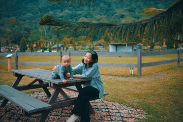 Fototapeta premium A heartwarming scene shows a mother and child joyfully enjoying natures beauty together