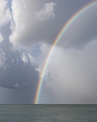 a rainbow with clouds on plain white background