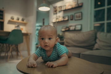 A happy baby explores a cozy, inviting table in a home filled with joy and comfort