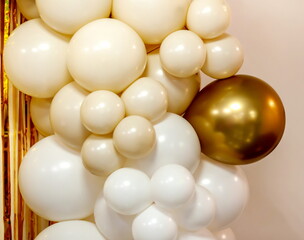 White and gold festive balloons as room wall decoration