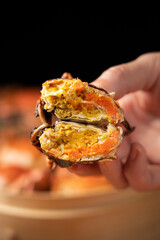 steamed hairy crab meat in hand close up.