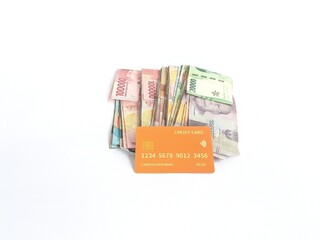 Rupiah banknotes and credit cards on a white background
