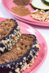 Homemade pastry made of zucchini with nuts and raisin. White background