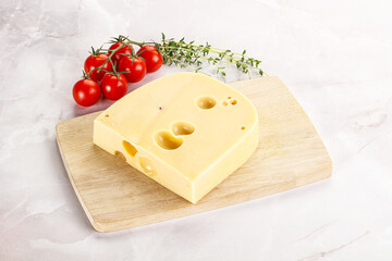 Maasdam cheese brick over board