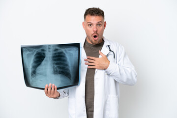 Professional traumatologist caucasian man isolated on white background surprised and shocked while...
