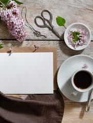 Greeting or invitation card mockup with gift box, envelope and spring lilac flowers