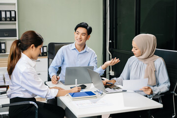 Happy businesspeople while collaborating on a new project in an office.