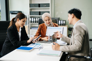 Asian businesspeople while collaborating on a new project.  using a laptop and tablet