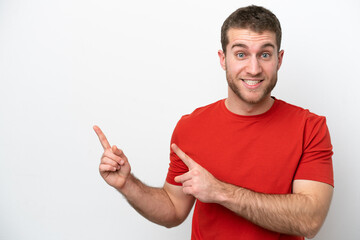 Fototapeta premium Young caucasian man isolated on white background frightened and pointing to the side