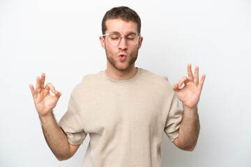 Fototapeta premium Young caucasian man isolated on white background in zen pose
