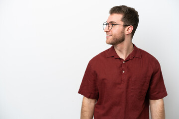 Fototapeta premium Young caucasian man isolated on white background looking side