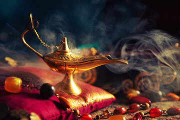 Precious golden magic lamp with smoke on silk pillow. Arabian night.