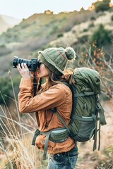Obraz premium A Hiking woman checking photographs on her camera