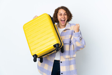 Young English woman isolated on white background in vacation with travel suitcase