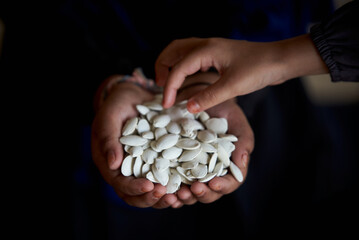 Hands holding a pile of healthy roasted pumpkin seed