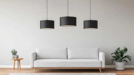 A modern living room featuring a light grey sofa, hanging black lamps, and a touch of greenery, creating a sleek and inviting atmosphere.