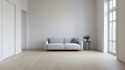A minimalist living room featuring a light-colored sofa, a small table, and natural light filtering through large windows.