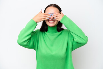 Young caucasian woman isolated on white background covering eyes by hands and smiling