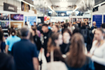Abstract blurred people at exhibition hall of expo event trade show. Business convention show or...