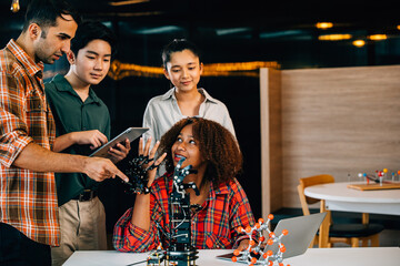 Engaged students and teacher learning together on a robotic arm in a classroom. Fostering innovation teamwork and practical education in a fun setting. Robot hand. Innovation and technology concept