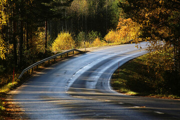Fototapeta premium Curvy road on the hill with autumn colors at Pertunmaa, Eastern Finland.