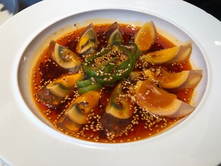 Sliced century egg with chili and sesame, cold dish, preserved egg