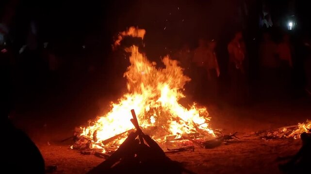 Pamekasan, indonesia - October 12, 2024. Bonfire burning in scout camp at night very amazing with some kids around